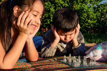 brothers play chess in the courtyard of their house outdoors