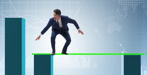 Fototapeta premium Young businessman in business concept with bar charts