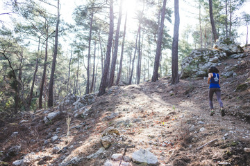 Fototapeta premium A woman runs along a mountain trail.