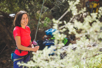 A woman is belaying a partner.