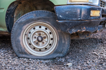 Fototapeta na wymiar Old car with flat tire