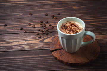 Cup with coffee on a rural wooden tabletop. Latte or cappuccino with chocolate sprinkles. copy space. 
