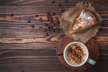 Cup with coffee and apple pie on a rural wooden tabletop. Latte or cappuccino with chocolate...