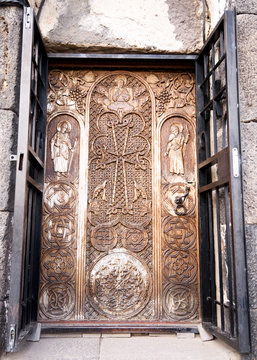 Sevan peninsula. Armenia-May, 01 2019: Carved wooden door with biblical plot. Sourp Arakelots, Sevanavank monastery, Armenia