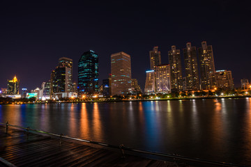Fototapeta premium Modern building light with pond public park at night