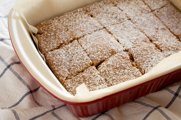 Homemade Tasty Applesauce Cake on a white wooden background, low angle view. Close-up.