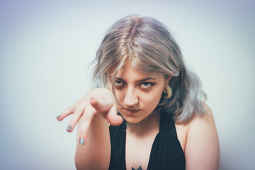 Fototapeta premium studio portrait of a beautiful girl pointing to the camera