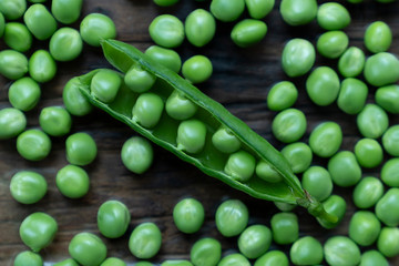 Fresh Green Peas and pods on wood table