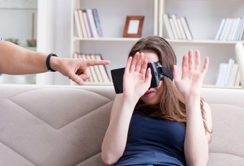 Young family playing games with virtual reality glasses