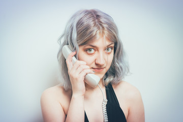 Woman Talking On Landline Telephone, Indoors