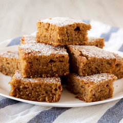Homemade Tasty Applesauce Cake on a white plate, side view. Close-up.