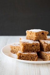Homemade Applesauce Cake on a white plate, side view. Close-up.
