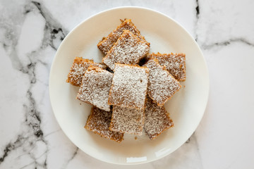 Homemade Tasty Applesauce Cake on a white plate, top view. Flat lay, overhead, from above.