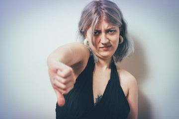 Woman showing a thumb down gesture