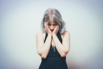  Woman covers his face by hand