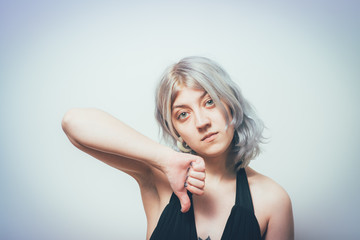 Woman showing a thumb down gesture