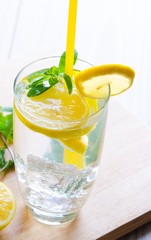 Glasss of mojito with lemon and drinking straw