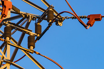 High voltage towers against blue sky