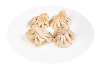 boiled khinkali sprinkled with pepper on plate