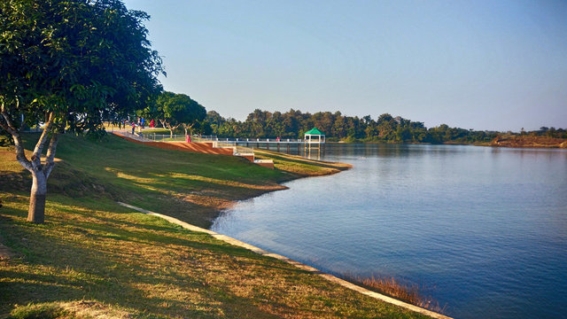 Landscape with lake, bridge, and trees