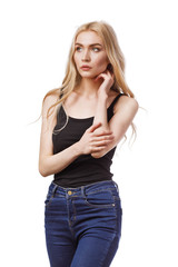 Blonde girl looks thoughtfully to the side. Model isolated on white background