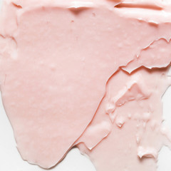Pink cosmetic cream smear on white background. Peach color beauty creme swipe. Skincare product creamy texture. Color corrector smudge swatch. Skin care. Mask for the face or body