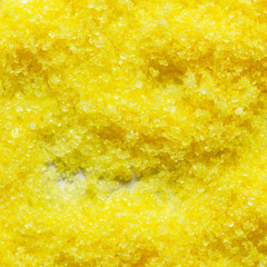 A top view of the loose yellow bath sea salt. Cut view. Close-up. Texture. Background. Body skin care and spa concept