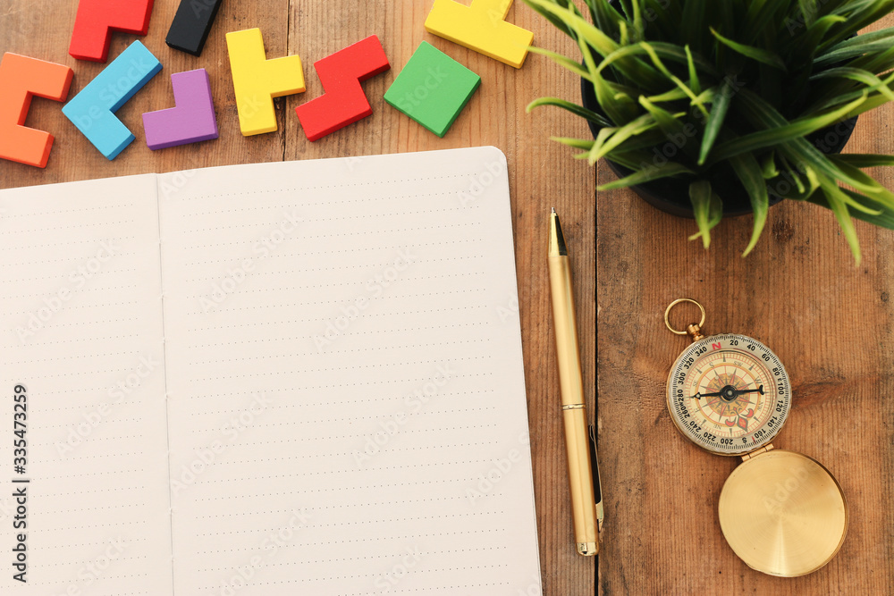 Fototapete top view image of open notebook with blank pages next to cup of coffee on wooden table. ready for ad