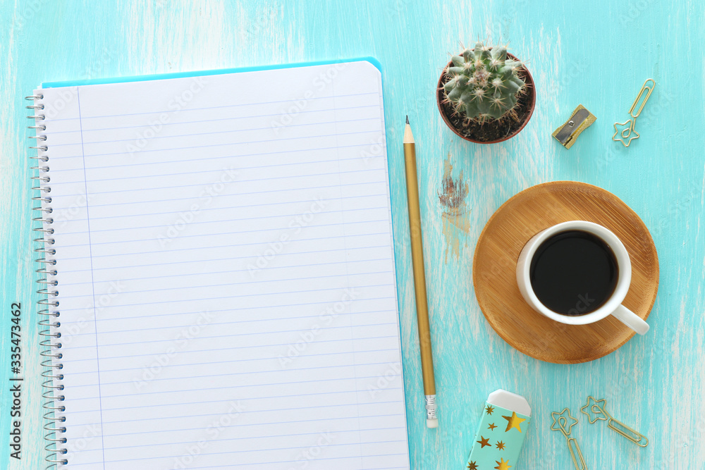 Fototapete top view image of open notebook with blank pages next to cup of coffee on wooden table. ready for ad