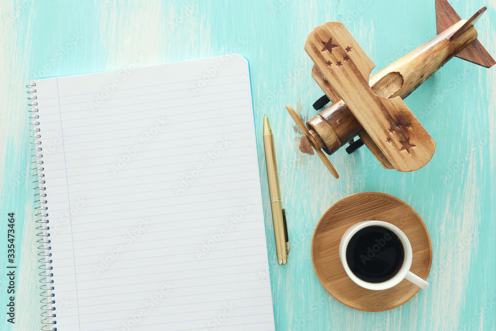 Fototapete top view image of open notebook with blank pages next to cup of coffee on wooden table. ready for ad