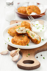 Delicious crispy fried breaded chicken patties with sauce.
