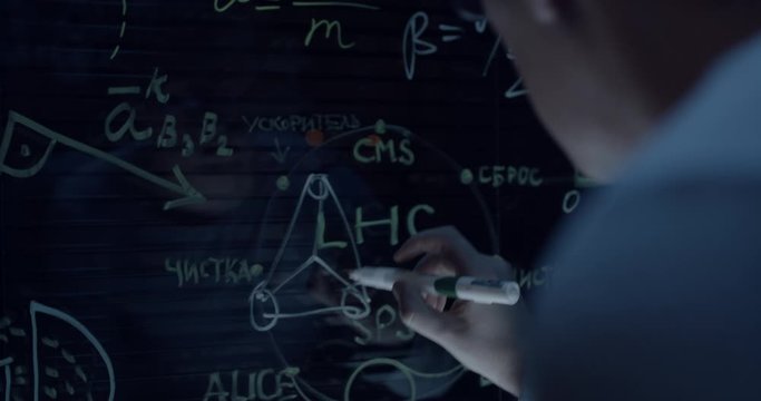 scientist at work writes the formula on the glass
