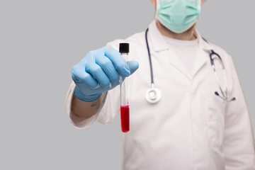 Doctor Showing Blood Analysis Wearing Gloves and Medical Mask. Blood Analysis Close Up.