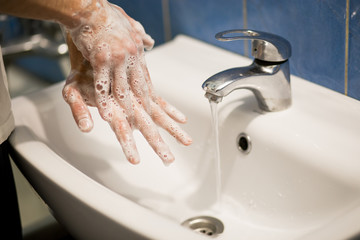Hygiene concept. Washing hands with soap foam