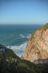 Portugal atlantic coast, waves crashing on the rocks warm sunny day horizon