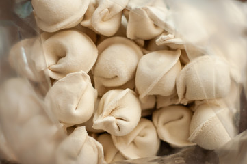 Frozen dumplings close-up in a transparent package.