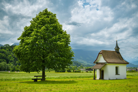 Bench under the tree close to small chapel near Wichelsee close to Sarnen in Switzerland