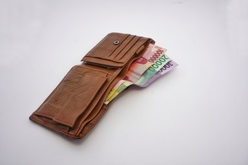wallet and money on a white background