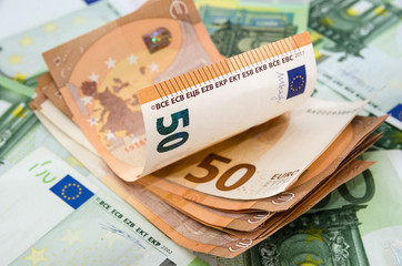 stack of 50 euros on a background of euro banknotes.