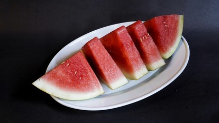 Fresh red watermelon slices. Efficacious watermelon to prevent asthma, lower blood pressure, ward off dangerous cancer cells, smooth digestion, prevent inflammation, and a natural source of collagen.