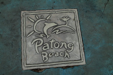 Iron plate on the asphalt. Phuket, Thailand. Wallpaper and background texture.
