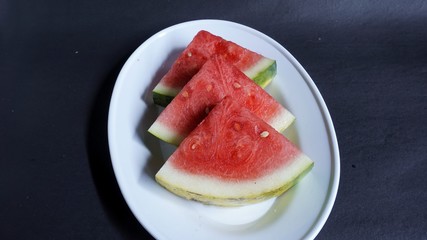 Fresh red watermelon slices. Efficacious watermelon to prevent asthma, lower blood pressure, ward off dangerous cancer cells, smooth digestion, prevent inflammation, and a natural source of collagen.