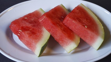 Fresh red watermelon slices. Efficacious watermelon to prevent asthma, lower blood pressure, ward off dangerous cancer cells, smooth digestion, prevent inflammation, and a natural source of collagen.