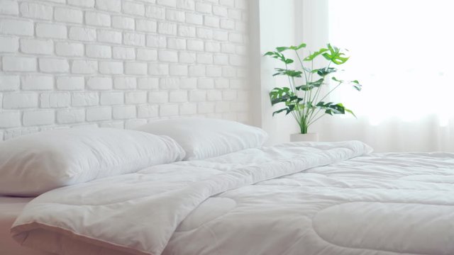 bed with white pillow and blanket with natural light in bedroom in the morning,bed and Cozy Bedroom Concept