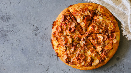 Pizza on rustic grey background, top view. Pizza with minched meat, celery and Mozzarella Cheese close up.