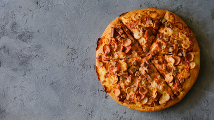 Pizza on rustic grey background, top view. Pizza with minched meat, celery and Mozzarella Cheese close up.