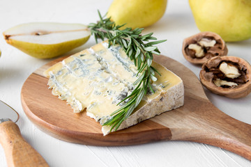 gorgonzola cheese, pears, rosemary and walnuts on the table