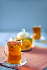 Selective focus photo of citrus tea with lemon, orange and mint
