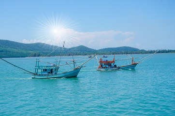 Couple fishing boats sail in blue sea of Thailand