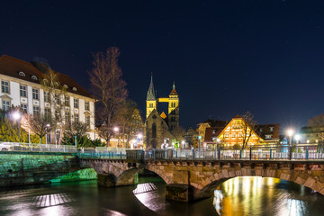 Fototapeta na wymiar Germany, Medieval city esslingen am neckar in magical atmosphere by night with starry sky and illuminated buildings and bridge over river